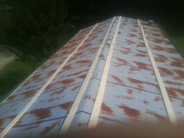 Rusted metal roof panels with new wood purlins before replacement — Storm Damage Roof Repair in Tornado by Roofing Brothers